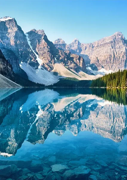 Scenic view of mountains and glaciers reflecting off of a lake, representing investing